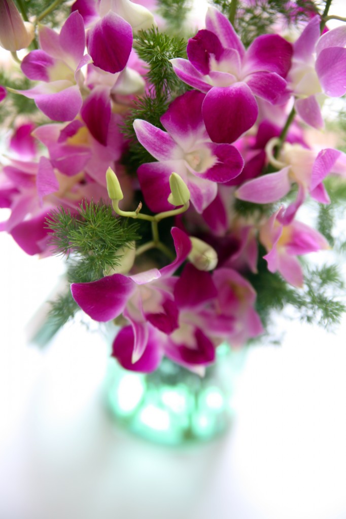 pink orchids in blue ball jar